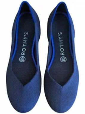 Rothy's navy blue round-toe knit flat shoes featuring a distinctive bright blue